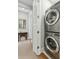 Convenient laundry area with stacked washer and dryer and stylish barn door at 104 May Ln, Mount Pleasant, SC 29464