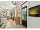 Inviting living room features a decorative chandelier, hardwood floors, and view to a garden at 104 May Ln, Mount Pleasant, SC 29464