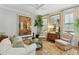 Sophisticated living room featuring neutral furnishings, layered rugs and custom window treatments at 104 May Ln, Mount Pleasant, SC 29464