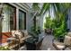 Outdoor seating on the patio with lush greenery surrounding the table and chairs at 104 May Ln, Mount Pleasant, SC 29464
