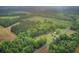 Aerial view of lush property with woods and open spaces, plus a building, providing a secluded atmosphere at 1050 Mt Zion Rd, Saint George, SC 29477