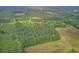 Expansive aerial view of a wooded property with fields and lush greenery offering privacy and natural beauty at 1050 Mt Zion Rd, Saint George, SC 29477