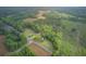 Sprawling property featuring a home surrounded by lush greenery and fields viewed from above at 1050 Mt Zion Rd, Saint George, SC 29477