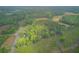 Lush green acreage with a cozy home and an RV, surrounded by dense woodlands at 1050 Mt Zion Rd, Saint George, SC 29477