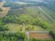 Vast acreage with a mix of forests and open fields including a home, RV, and outbuildings at 1050 Mt Zion Rd, Saint George, SC 29477