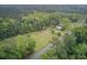 An overhead view of a home and surrounding property with mixed trees and grass, emphasizing seclusion and quiet living at 1050 Mt Zion Rd, Saint George, SC 29477