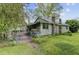 Home exterior needing TLC, featuring an older facade, fenced yard, and some overgrown foliage at 1050 Mt Zion Rd, Saint George, SC 29477