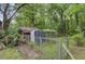 Wooden shed with a fenced yard providing secure storage and space for outdoor activities at 1050 Mt Zion Rd, Saint George, SC 29477