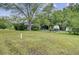 Spacious yard with mature tree and manicured lawn, featuring a charming home and RV in the background at 1050 Mt Zion Rd, Saint George, SC 29477