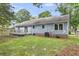 Back exterior view showing siding, brick foundation, and wooden deck at 106 Chaff Ct, Summerville, SC 29485