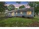 Back exterior view of home with access to sliding glass door and wooden deck at dusk at 106 Chaff Ct, Summerville, SC 29485