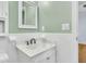 Neat bathroom featuring a white vanity and a sleek mirror, complemented by light green walls at 106 Chaff Ct, Summerville, SC 29485