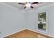 Bright bedroom featuring hardwood floors, a ceiling fan, and a window view of the outdoors at 106 Chaff Ct, Summerville, SC 29485