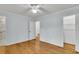Sunlit bedroom boasting hardwood floors and a ceiling fan, enhanced by convenient closet and bath access at 106 Chaff Ct, Summerville, SC 29485