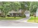 Charming single-story home featuring a well-manicured lawn, lush trees, and a welcoming facade at 106 Chaff Ct, Summerville, SC 29485