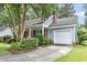 Charming home with blue siding, brick accents, a well-manicured front garden and an attached garage at 106 Chaff Ct, Summerville, SC 29485