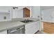Functional kitchen featuring white cabinets and an island countertop to living room at 106 Chaff Ct, Summerville, SC 29485