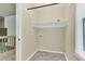 Practical laundry room with tile floors, a storage shelf, and a window for natural light at 106 Chaff Ct, Summerville, SC 29485