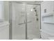 Modern bathroom shower with sleek glass doors, chrome fixtures and built-in shelving at 106 Chaff Ct, Summerville, SC 29485