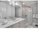 Modern bathroom features a sleek glass shower, quartz counters, and ample cabinet space at 108 Carolina Blvd, Isle of Palms, SC 29451