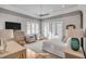Large main bedroom with a TV, shuttered windows, and a comfortable sitting area at 108 Carolina Blvd, Isle of Palms, SC 29451