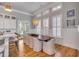Inviting dining area features a large wooden table and connects to a fully equipped kitchen at 108 Carolina Blvd, Isle of Palms, SC 29451