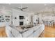 Open-concept living area with hardwood floors, fireplace, and built-in shelving connects to the kitchen at 108 Carolina Blvd, Isle of Palms, SC 29451