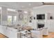 Bright living room features a decorative fireplace, hardwood floors, and plenty of natural light at 108 Carolina Blvd, Isle of Palms, SC 29451