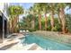 Backyard pool area with lounge chairs and mature landscaping provides a private oasis at 108 Carolina Blvd, Isle of Palms, SC 29451