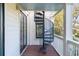 Charming porch featuring a black spiral staircase and white railing, perfect for outdoor access and curb appeal at 108 Carolina Blvd, Isle of Palms, SC 29451