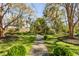 Lush backyard featuring a stone path, manicured lawn, and a charming pergola seating area at 1081 Groves Manor Ct, Mount Pleasant, SC 29464