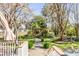 Charming backyard with lush greenery, a stone path, and a wooden pergola create a peaceful and inviting outdoor space at 1081 Groves Manor Ct, Mount Pleasant, SC 29464