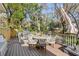 Backyard with a spacious deck, outdoor dining area, and mature trees at 1081 Groves Manor Ct, Mount Pleasant, SC 29464