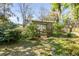 Charming backyard pergola with decorative lattice, steps, and stone path amidst lush landscaping at 1081 Groves Manor Ct, Mount Pleasant, SC 29464