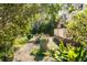 Concrete walkway runs through backyard with lush vegetation, mature trees, and a patio with outdoor seating at 1081 Groves Manor Ct, Mount Pleasant, SC 29464