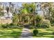 Stone path leads to a pergola and charming backyard. Lush greenery and trees create a private and serene retreat at 1081 Groves Manor Ct, Mount Pleasant, SC 29464
