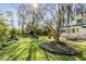 Lush backyard features manicured landscaping, mature trees, and a patio area perfect for outdoor entertaining or relaxation at 1081 Groves Manor Ct, Mount Pleasant, SC 29464