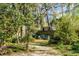 Inviting backyard seating area with lush greenery and mature trees providing shade and privacy at 1081 Groves Manor Ct, Mount Pleasant, SC 29464