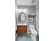 Modern bathroom featuring a wood vanity, updated light fixtures, and geometric floor tiles at 1081 Groves Manor Ct, Mount Pleasant, SC 29464