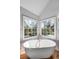 Modern bathroom with a freestanding tub under corner windows, providing a relaxing ambiance at 1081 Groves Manor Ct, Mount Pleasant, SC 29464