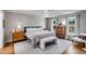 Bright bedroom with large windows, wood floors, and a tray ceiling with soft, neutral decor at 1081 Groves Manor Ct, Mount Pleasant, SC 29464