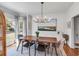 Stylish dining room bathed in natural light, features a modern chandelier, and a charming window view at 1081 Groves Manor Ct, Mount Pleasant, SC 29464