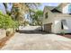 Spacious driveway leads to a home with a white exterior, a gray garage door, and manicured landscaping at 1081 Groves Manor Ct, Mount Pleasant, SC 29464