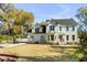 Elegant two-story home with manicured lawn, an inviting porch, and a classic American flag displayed at 1081 Groves Manor Ct, Mount Pleasant, SC 29464