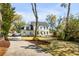 Beautifully landscaped home with a long driveway, lush lawn, and mature trees providing shade and curb appeal at 1081 Groves Manor Ct, Mount Pleasant, SC 29464