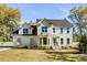 Charming home with large windows, manicured lawn, and inviting front porch, enhanced by beautiful landscaping at 1081 Groves Manor Ct, Mount Pleasant, SC 29464