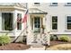 Charming home entrance with decorative front door, a bay window, beautiful landscaping, and inviting curb appeal at 1081 Groves Manor Ct, Mount Pleasant, SC 29464