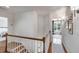 Second story hallway with wood floors and a staircase; a bedroom is visible at the end of the hall at 1081 Groves Manor Ct, Mount Pleasant, SC 29464