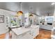 Open kitchen with a large island, farmhouse sink, and view of the breakfast nook and living room at 1081 Groves Manor Ct, Mount Pleasant, SC 29464