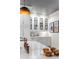 Bright kitchen area featuring custom cabinets with glass fronts, copper faucet, and artful decor at 1081 Groves Manor Ct, Mount Pleasant, SC 29464